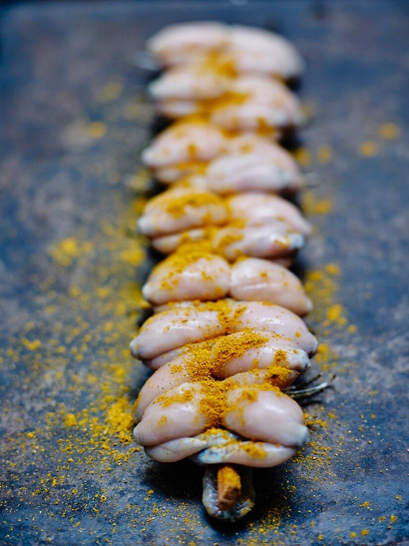 Raw frog's legs sprinkled with curry powder