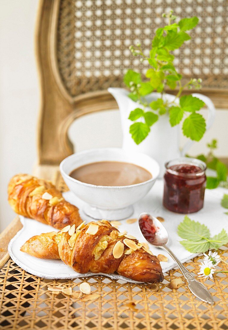 Marzipan and almond croissants, boiling hot cup of chocolate