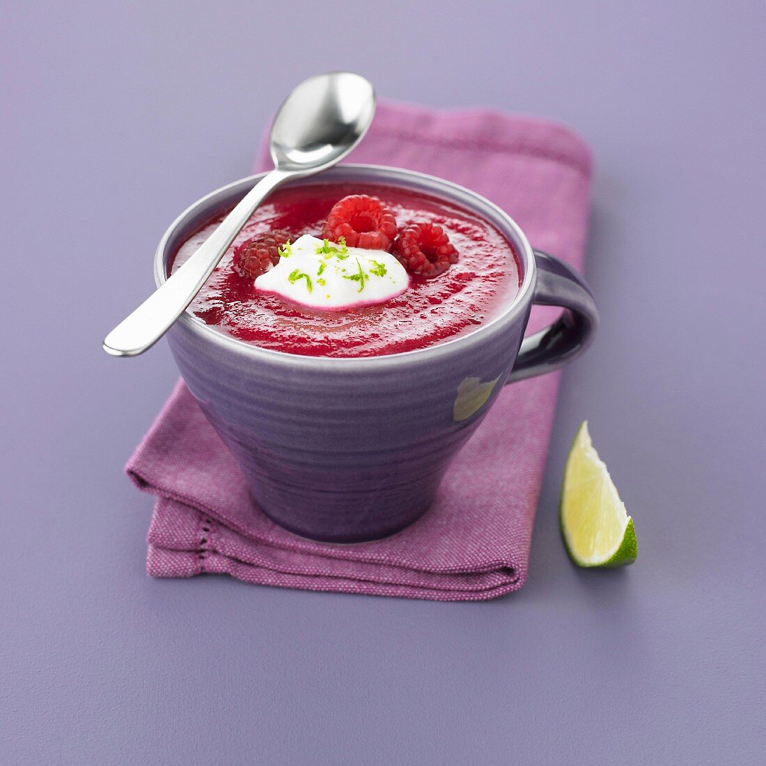 Cold beetroot soup with raspberries and lime cream