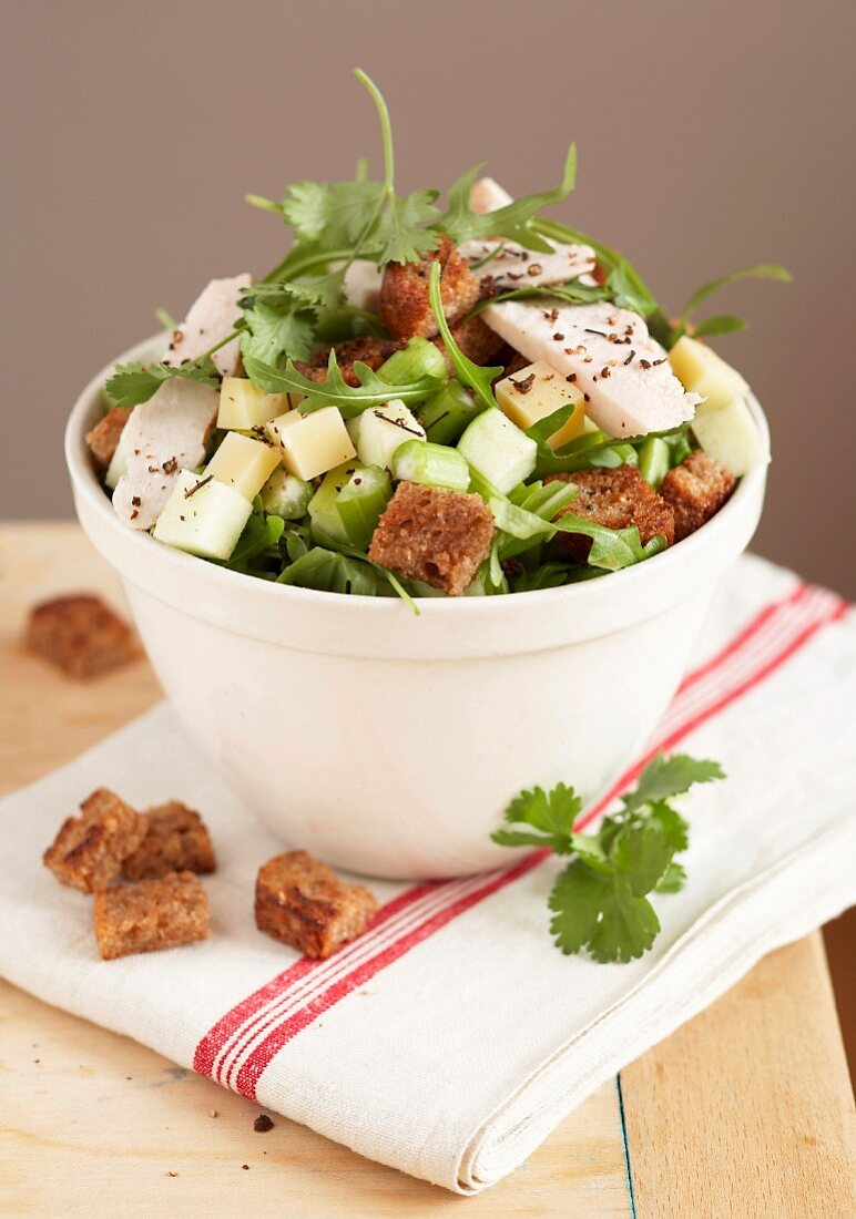 Chicken and diced cheese salad with croutons
