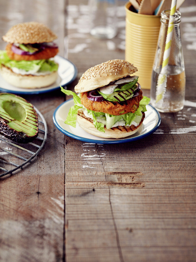 Burger with a grilled fish pattie and avocado