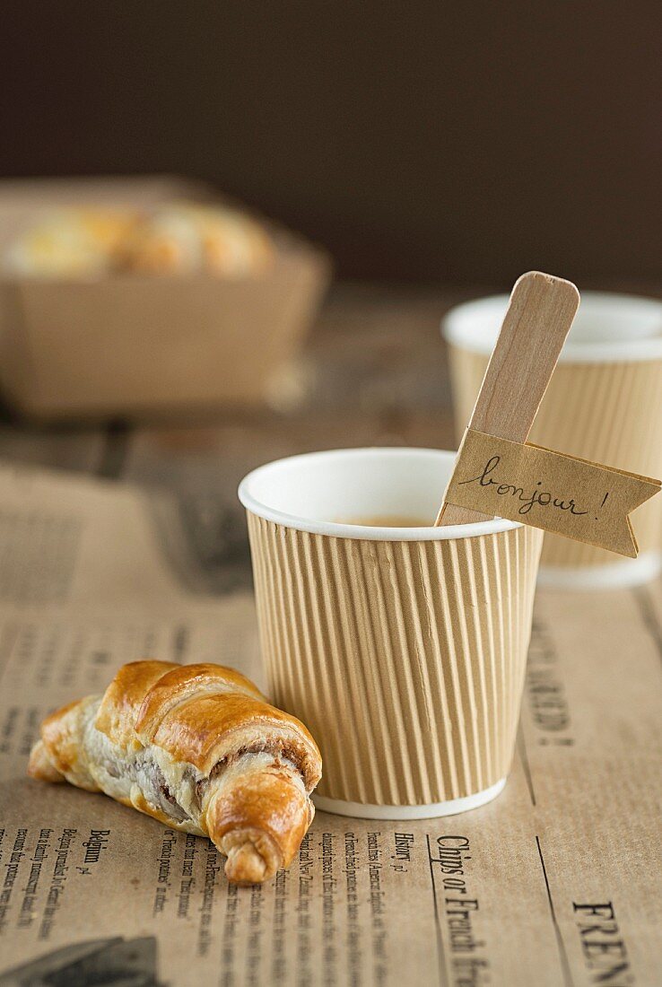 Mini Nutella croissant and a paper cup of coffee