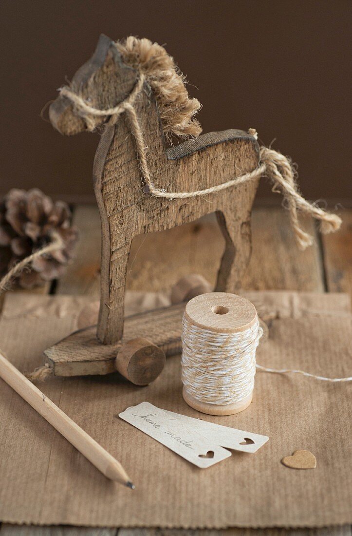 Reel of string, wooden horse and labels
