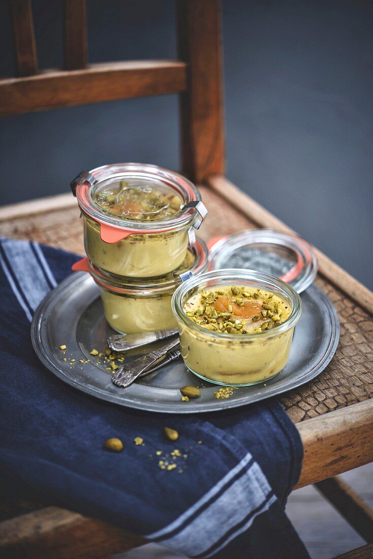 Jars of apricot and pistachio flans