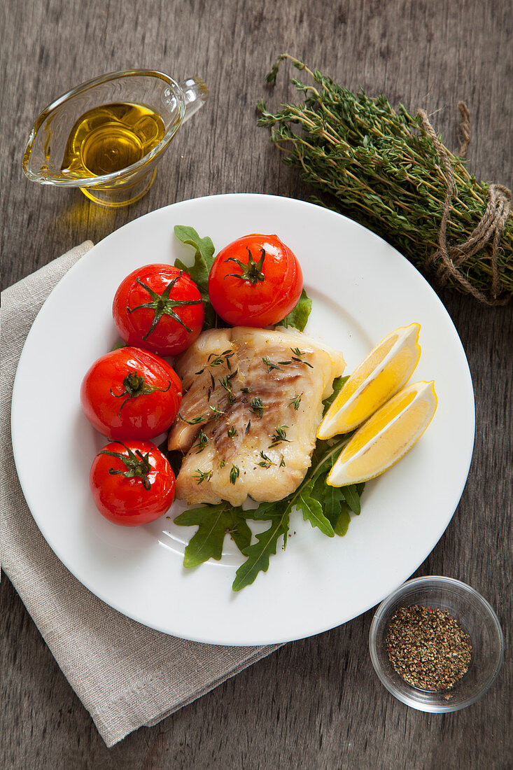 Hake with fresh thyme and baked tomatoes