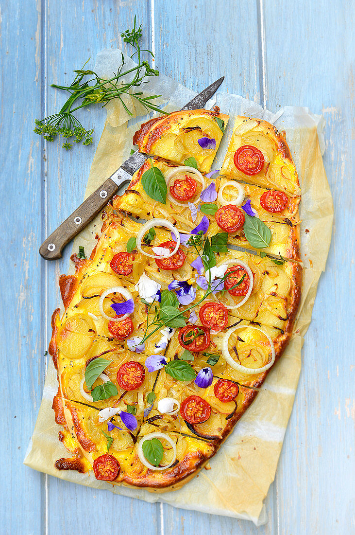 Tart with tomatoes, potatoes and edible flowers