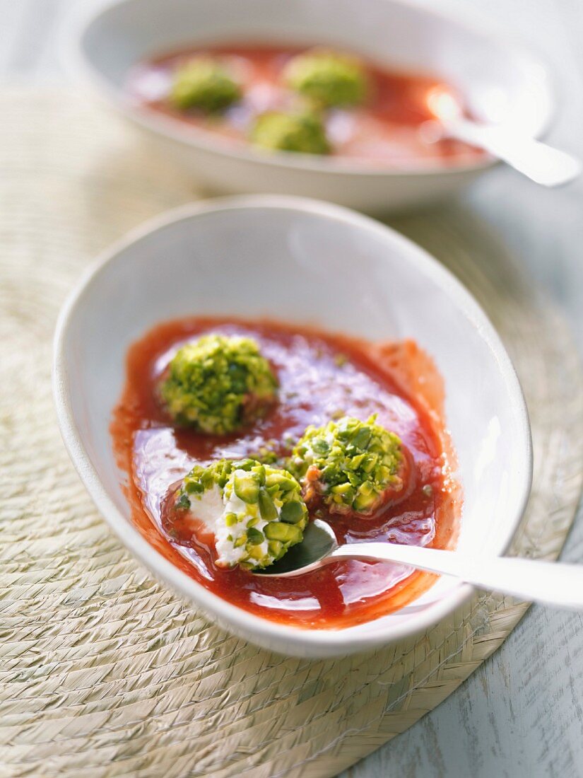Strawberry soup with ricotta balls topped with crushed pistachios