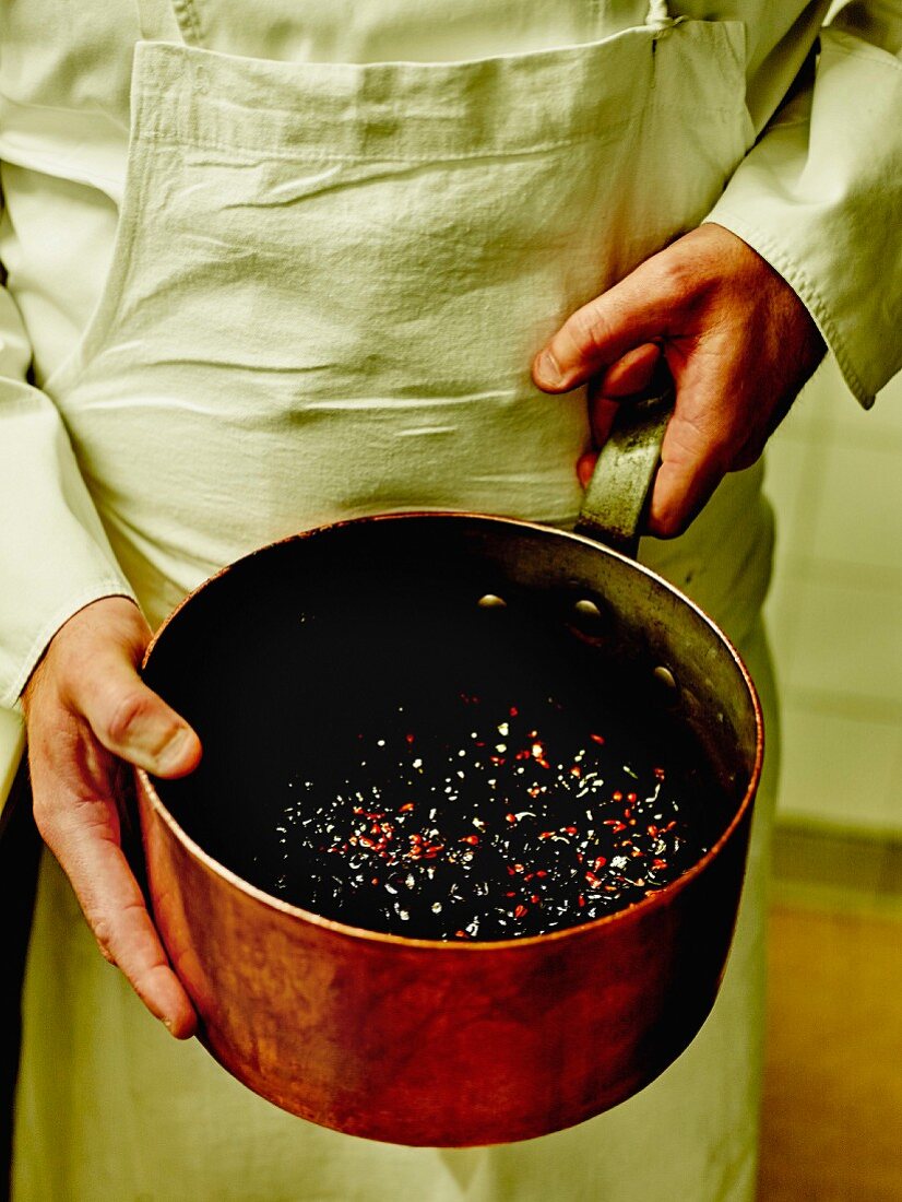 Cooking cherries in a copper saucepan