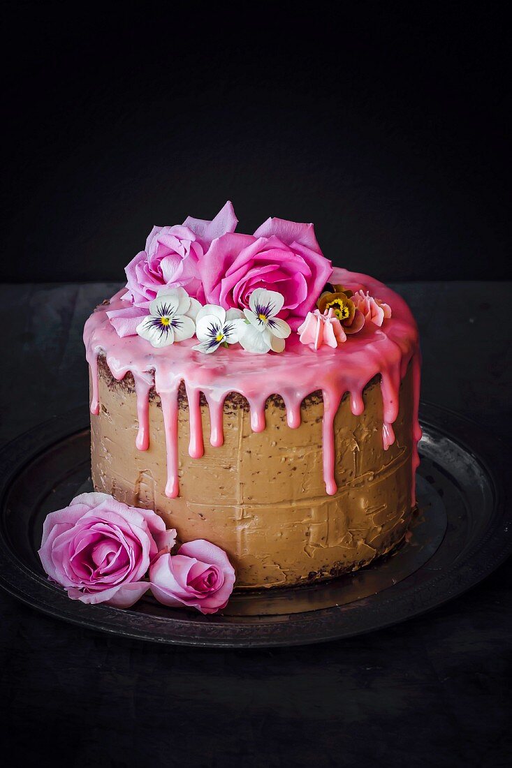 Chocolate layer cake topped with rose-flavored icing