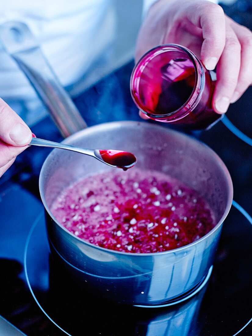 Blending in the natural rose extract with the mixed water, strawberry flavoring and coloring