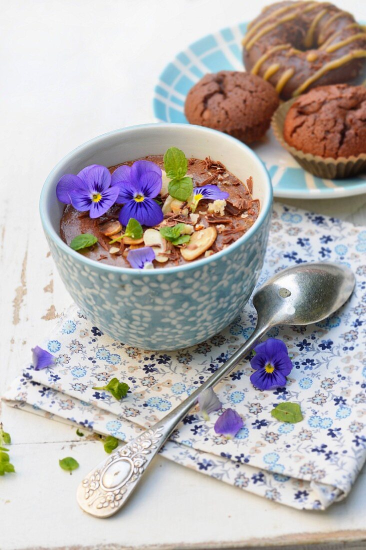 Chocolate mousse with almonds, hazelnuts, pansies and mint