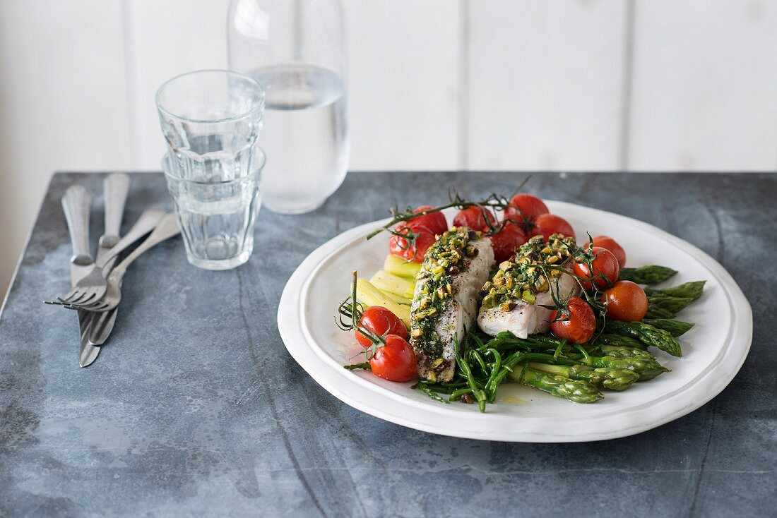 Cod fillet in herb crust, samphire, green asparagus and roasted tomatoes