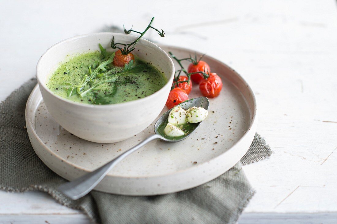 Courgette and rocket lettuce soup with mozzarella balls and roasted tomatoes