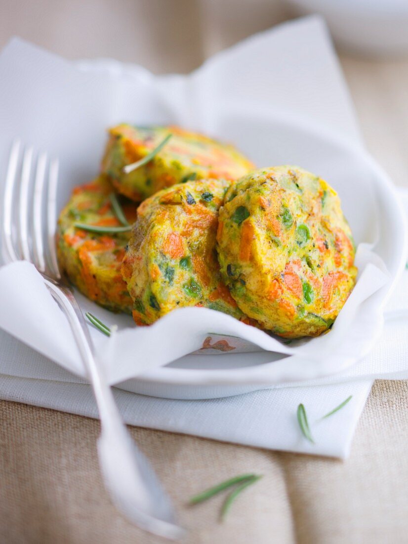 Yellow and green courgette, pea and carrot patties