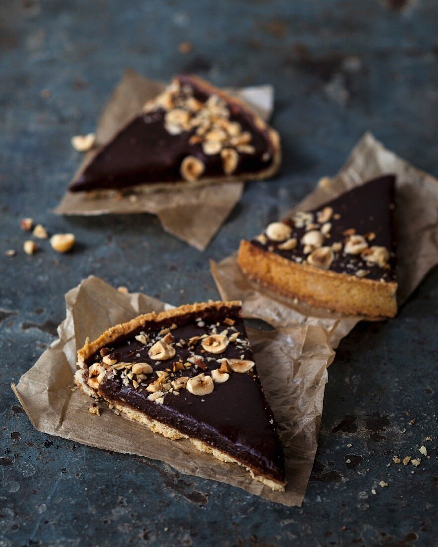 Chocolate ganache shortbread tart topped with roasted almonds and hazelnuts