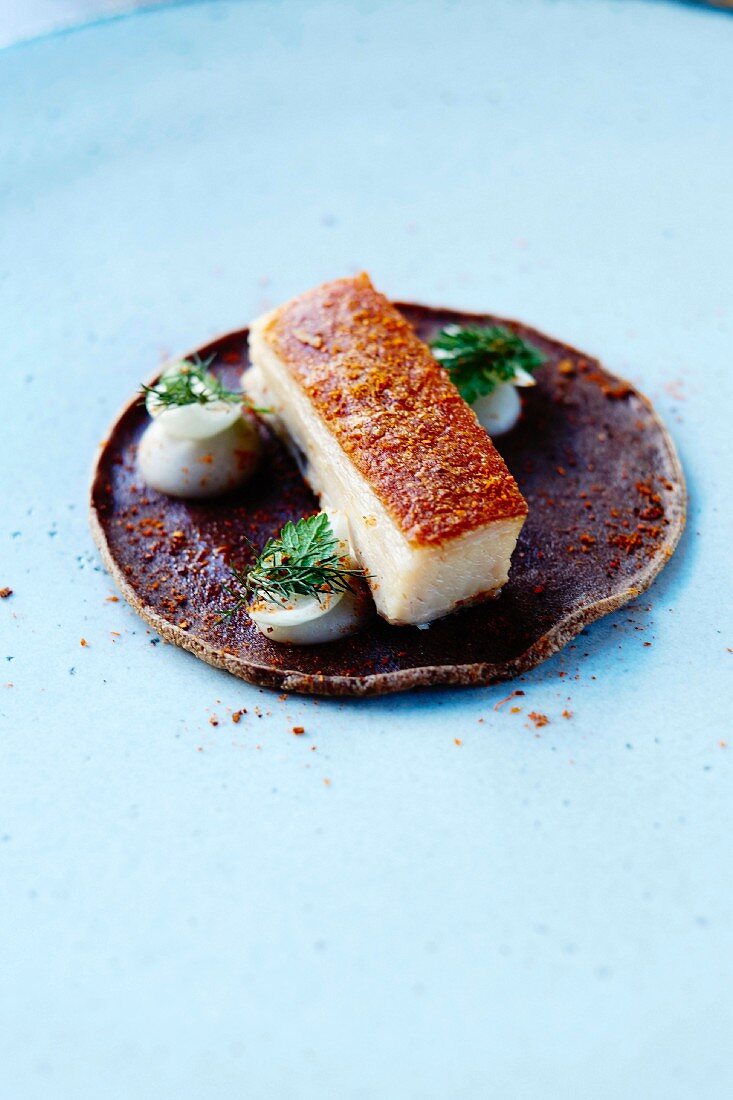 Crisp and spicy Ventrèche, pickled onions, white haricot bean buckwheat pancake