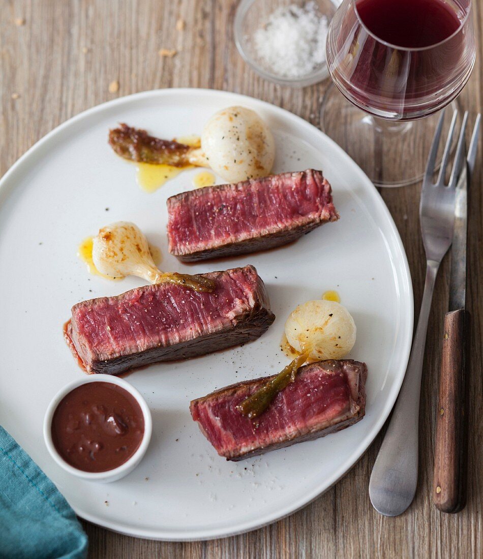 Grilled beef fillet, preserved spring onions, red wine sauce
