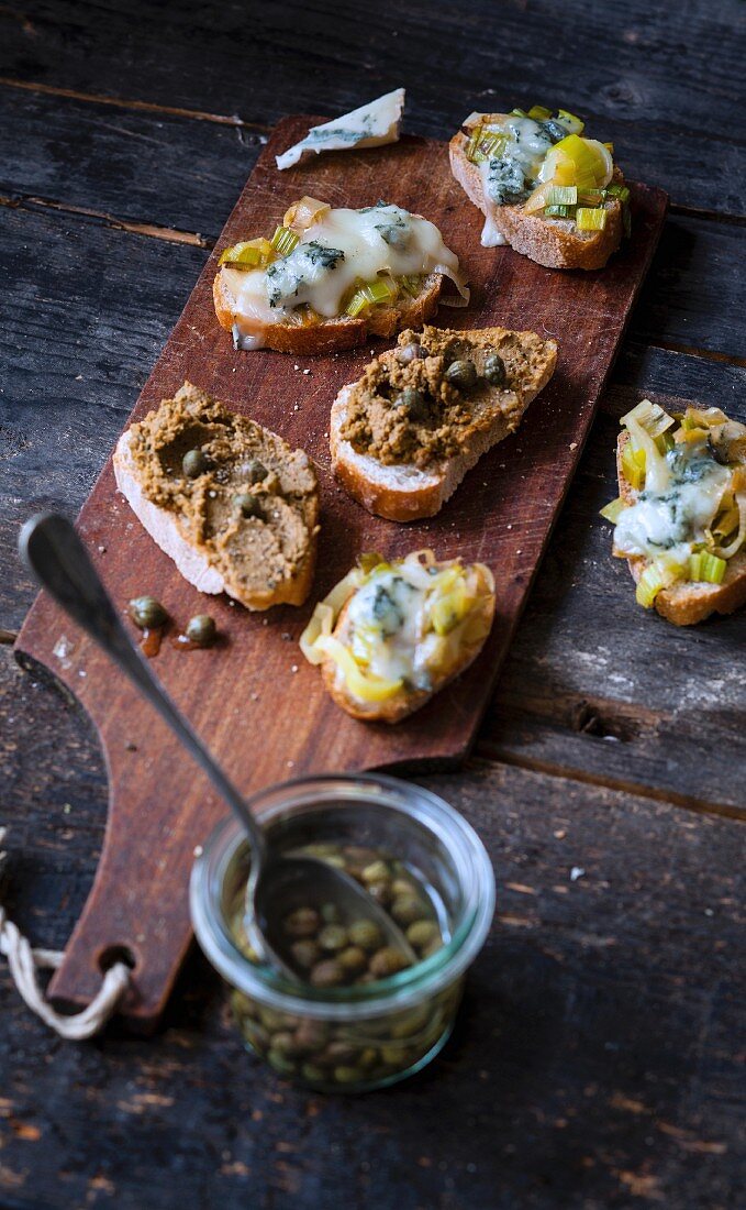 Caper tapenade crostinis and grilled leek fondue and gorgonzola crostinis