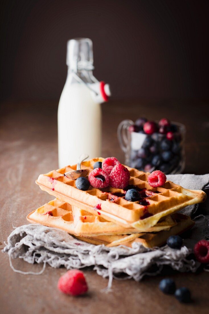Pile of plain Brussels waffles with red berry coulis