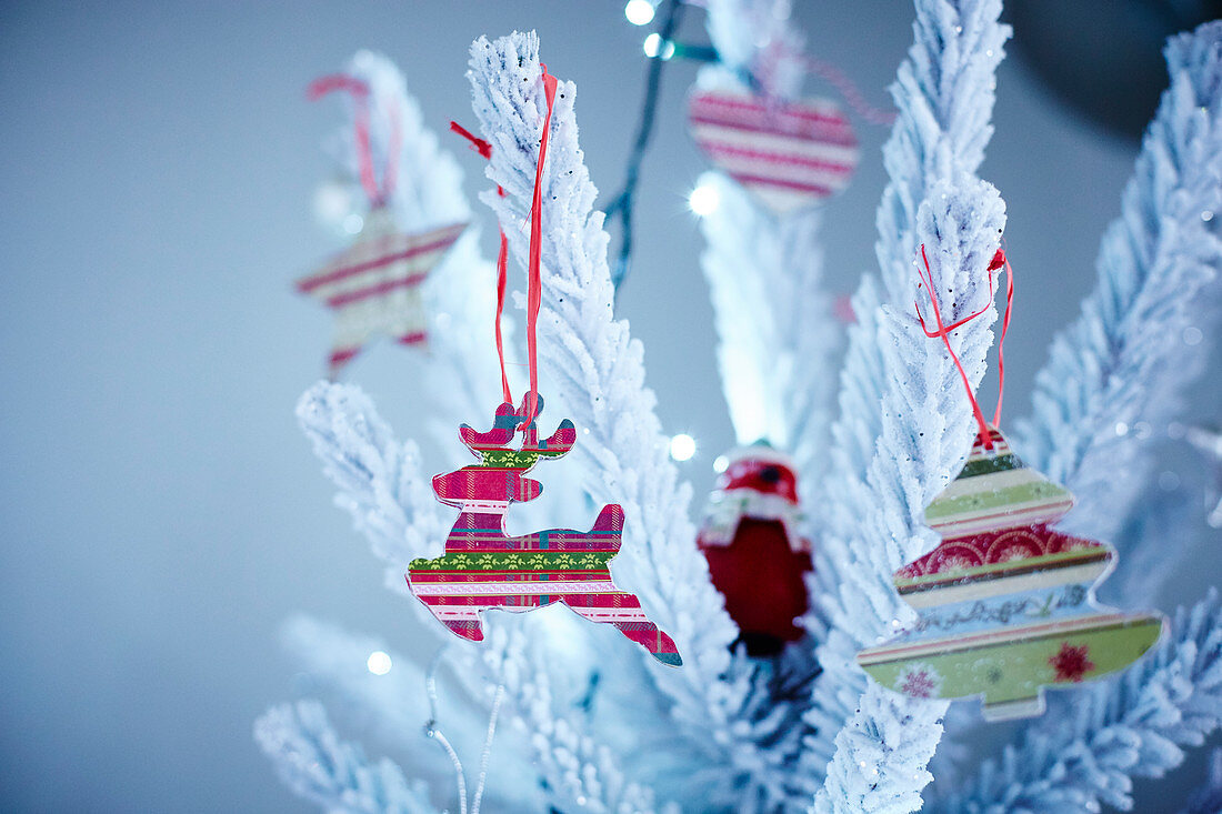 Christmas decorations on a snowy Christmas tree