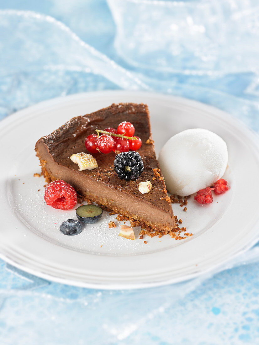 Slice of chocolate and chestnut tart with fresh berries