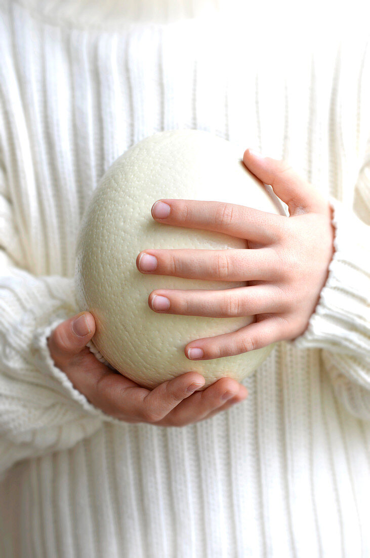 Child holding a white chocolate easter egg