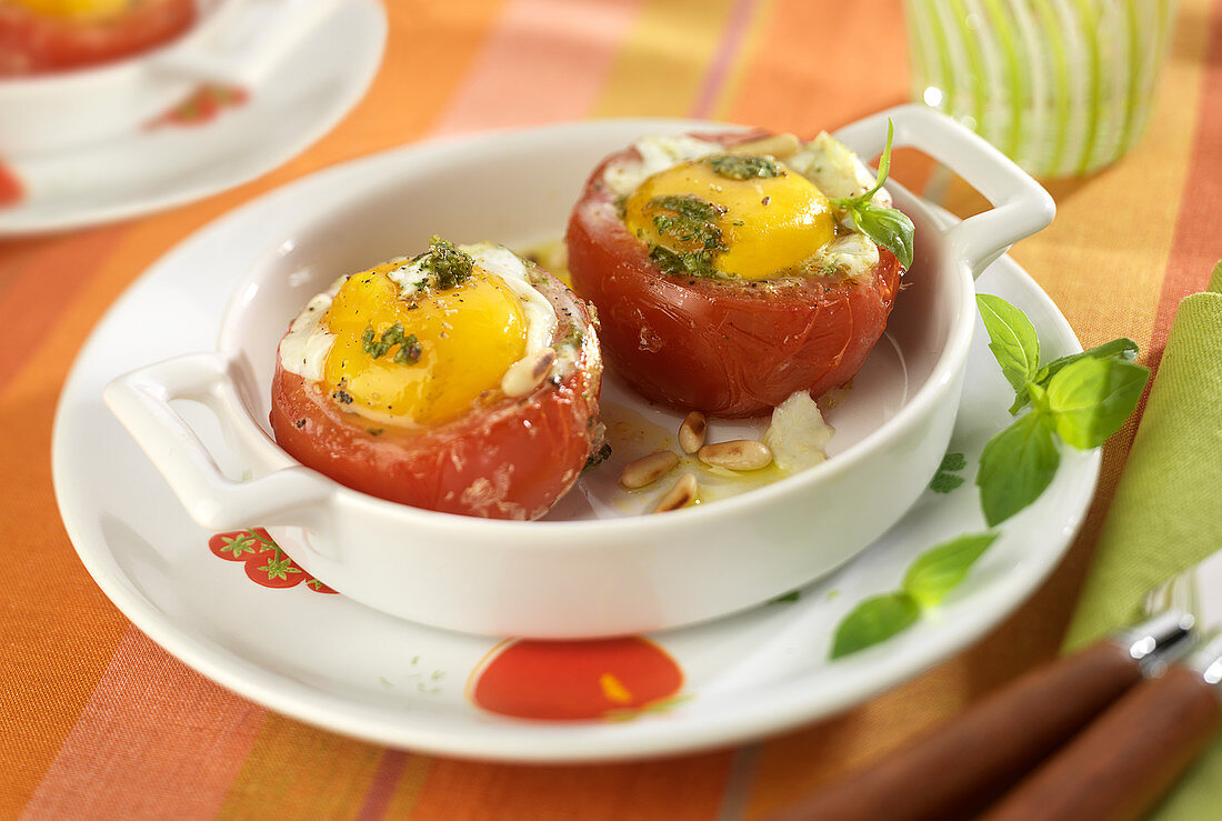 Eggs baked in tomatoes with basil pesto