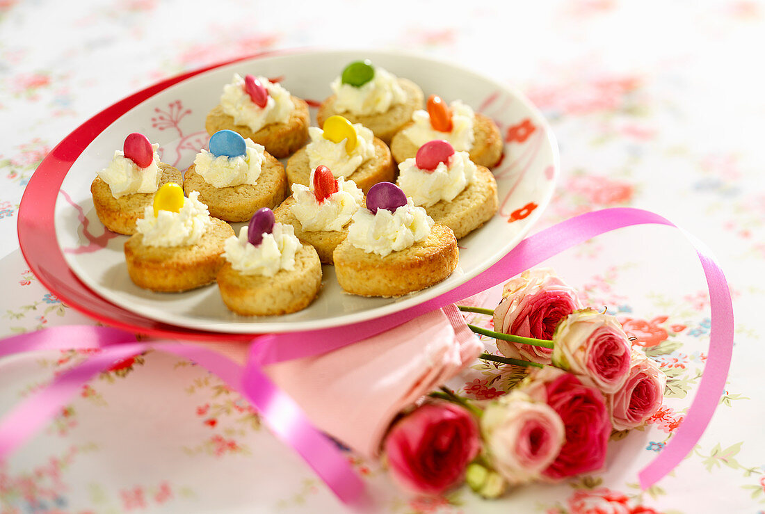 Shortbreads topped with whipped cream and Smarties