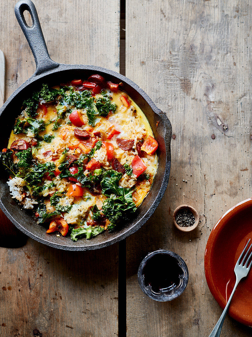 Tortilla with rice, vegetables and chorizo in a pan