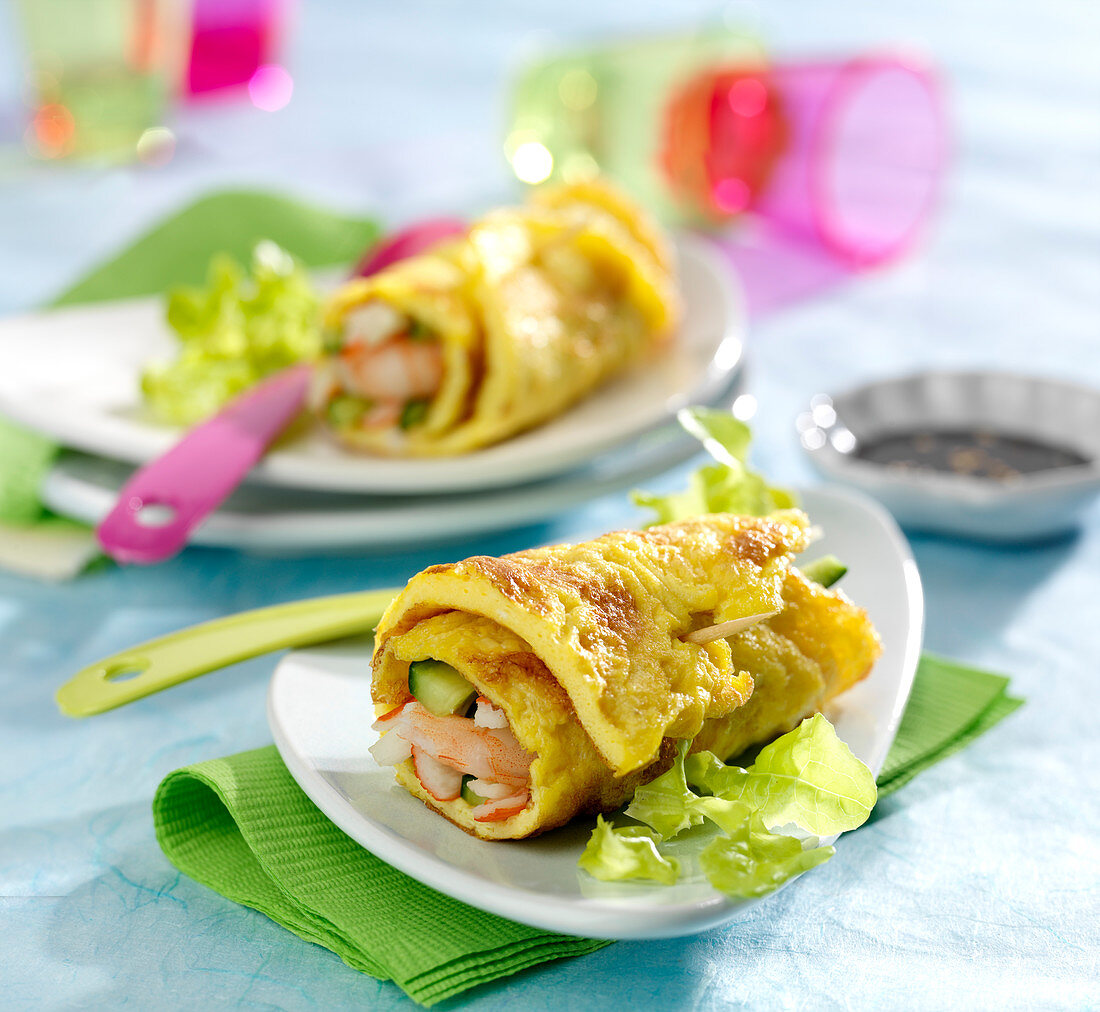 Omelette rolls garnished with shrimps and surimi crab