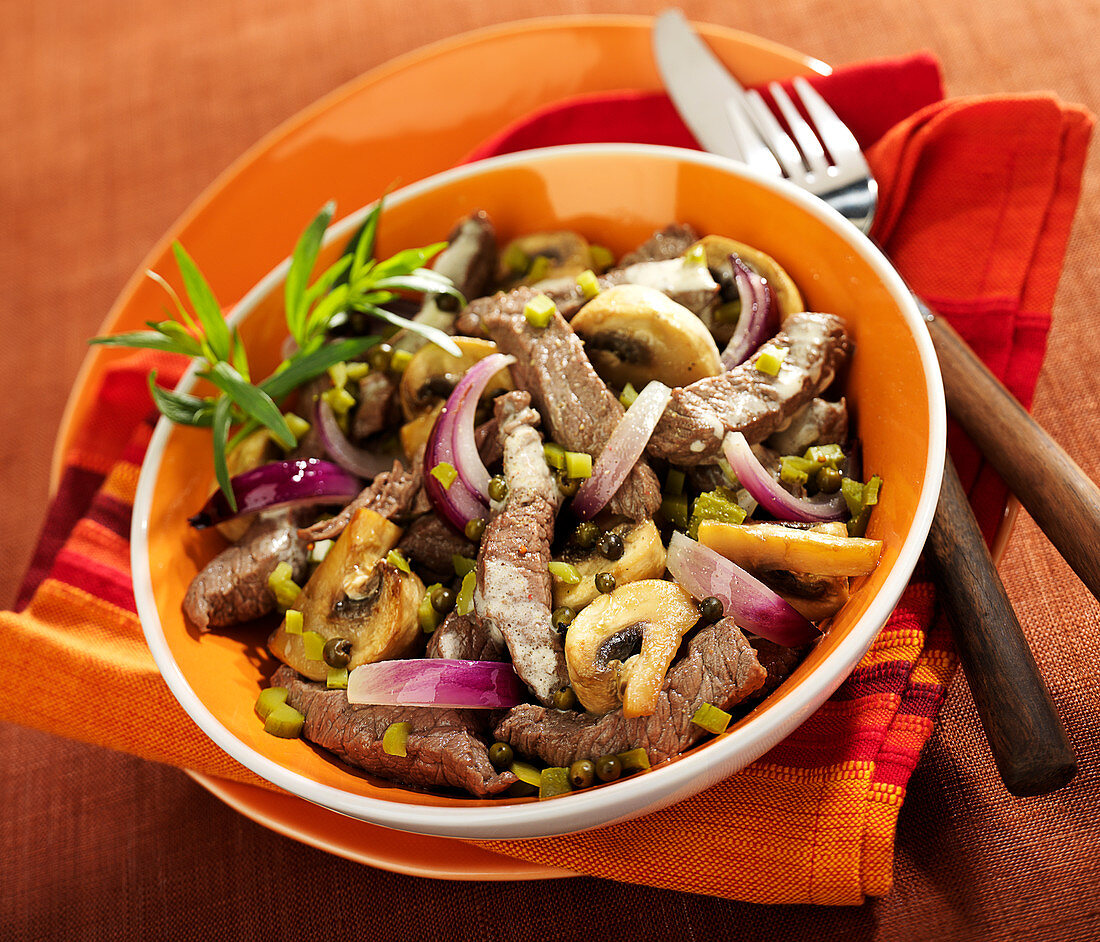 Thinly sliced beef with mushrooms, gherkins and red onions