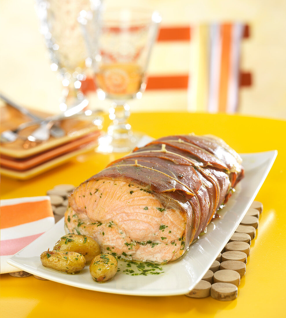 Salmon wrapped in bacon with parsley butter and sauteed potatoes