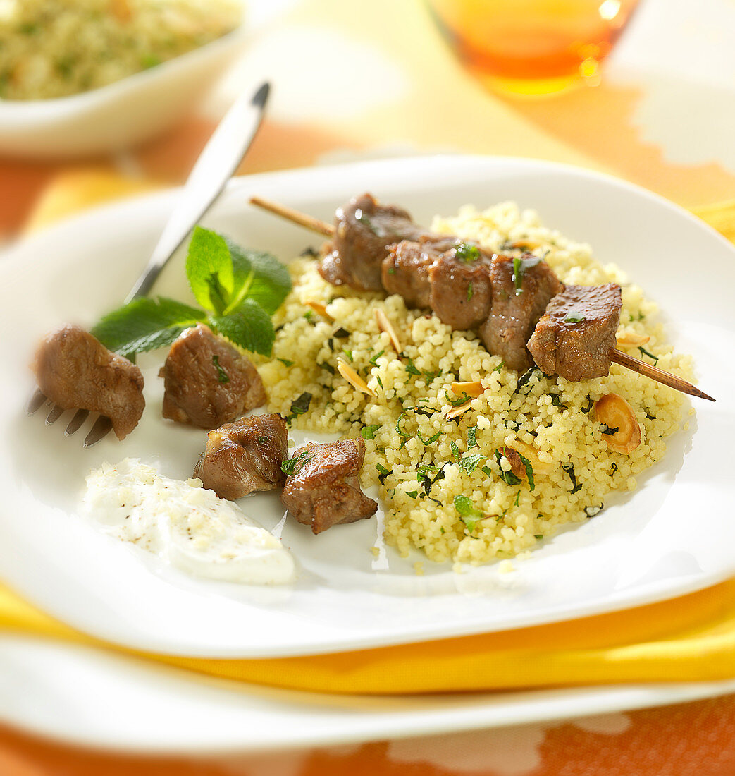 Grilled lamb brochette, semolina with mint and almonds,yoghurt sauce