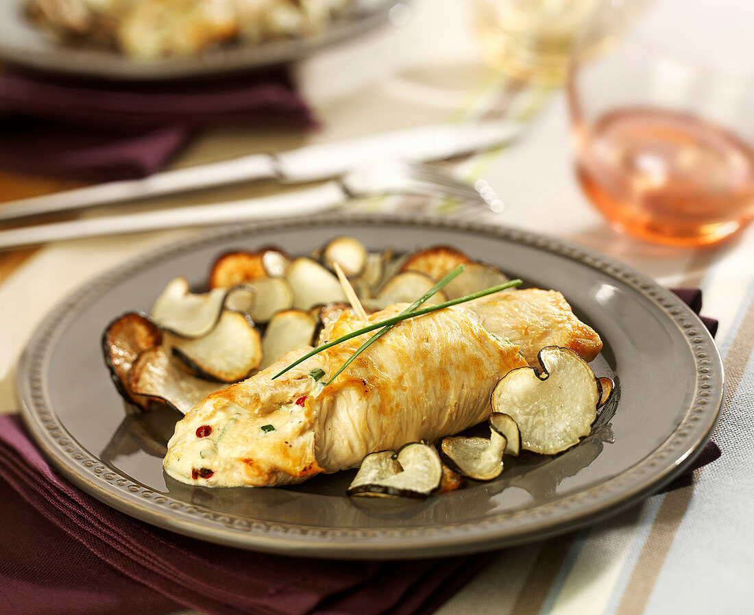 Rolled chicken breast stuffed with fromage frais, pan-fried black radish slices