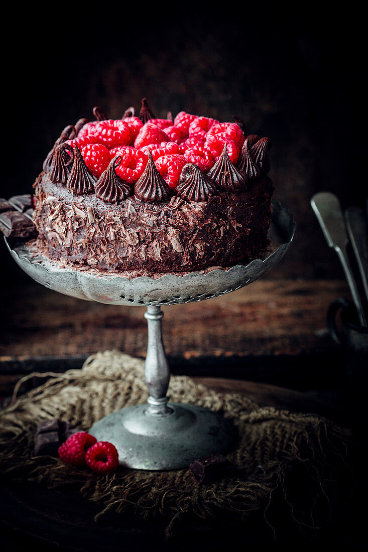 Chocolate mayonnaise cake with chocolate cream and raspberries