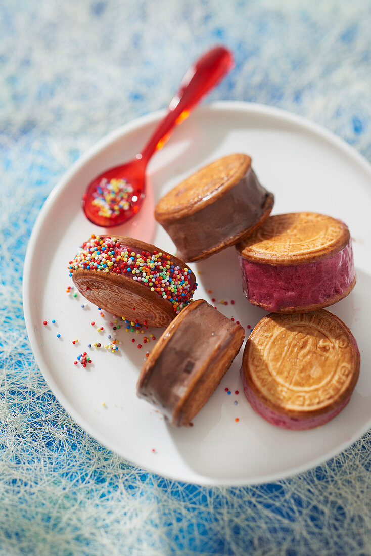 Small Breton cake sandwich with butter, chocolate ice cream, red fruit sorbet and multicolored sugar balls