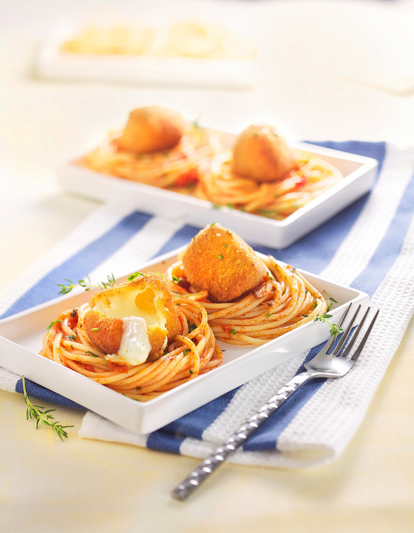 Spaghetti nest in tomato sauce and scamorza fritters