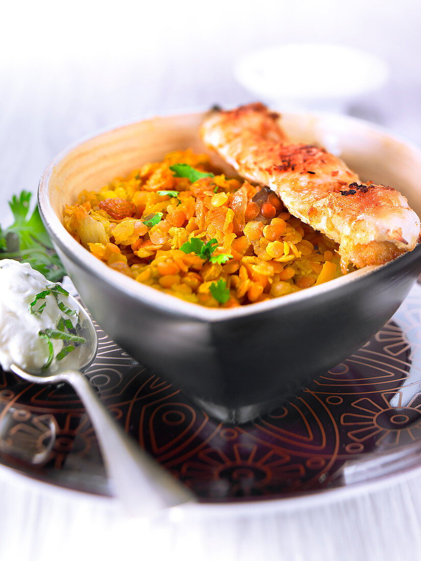 Orange lentil and raisin curry with chicken brochettes coated in coconut