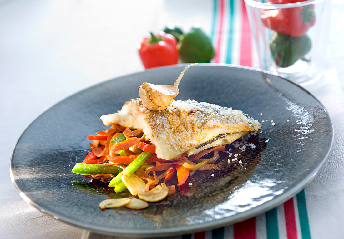 Sea bream fillet with garlic and three colored peppers