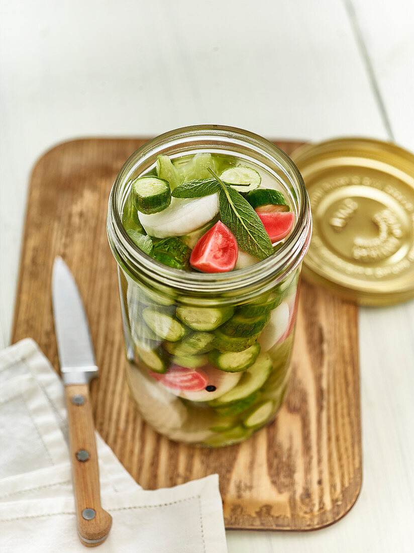 Jar Of Mini Cucumbers,Daikon,Sage And Red Radishes For Lacto-Fermentation