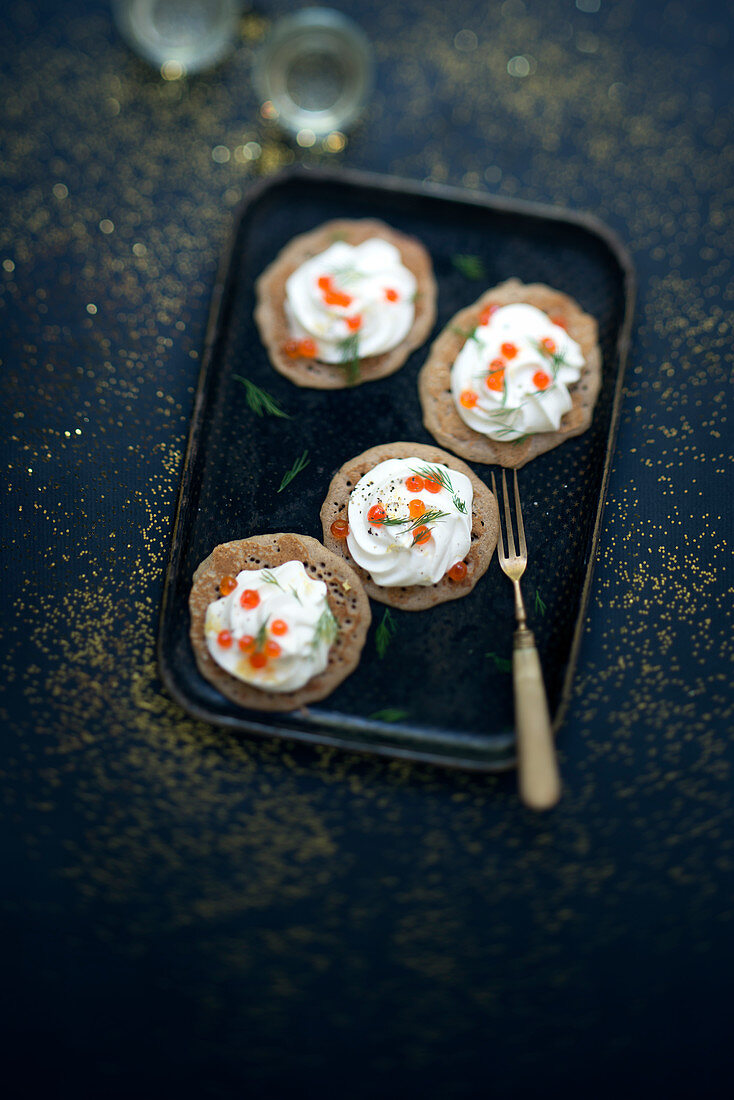 Blinis with cream and salmon roe