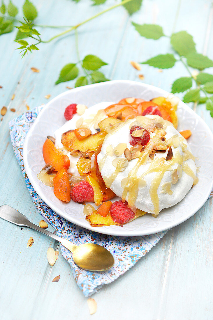 Pavlova with grilled almonds,caramel,roasted apples,apricots and raspberries