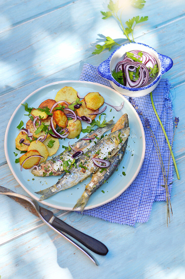 Sardines grilled with fresh herbs,sauteed potatoes and red onions