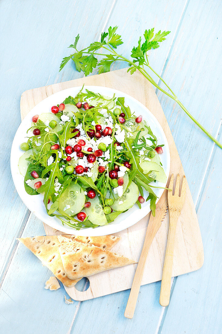 Rocket lettuce,cucumber,spinach,pea,feta,redcurrant and pomegranate seed salad