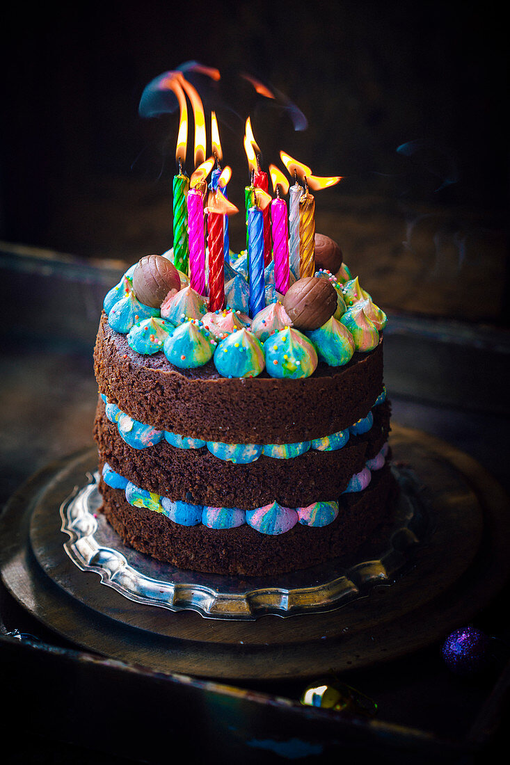 Chocolate birthday cake with blue cream and eastern eggs