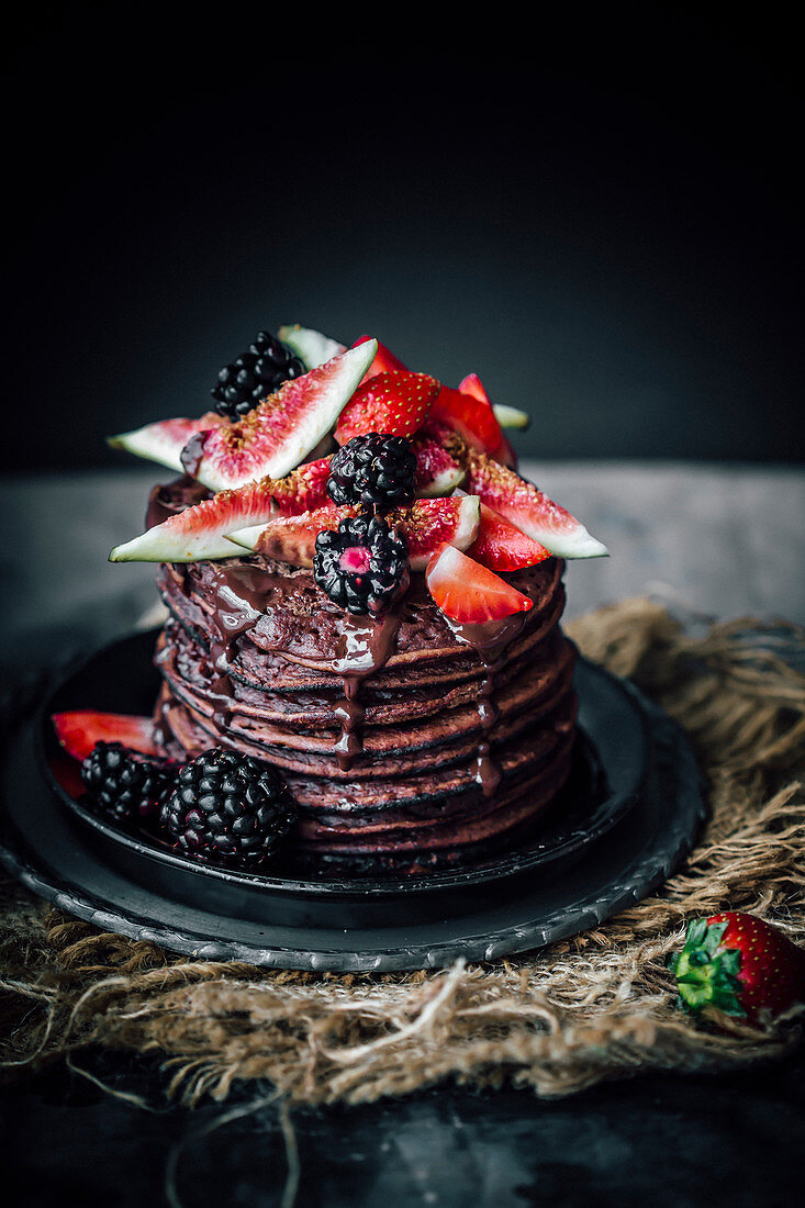 Banana chocolate pancakes with figs and berries
