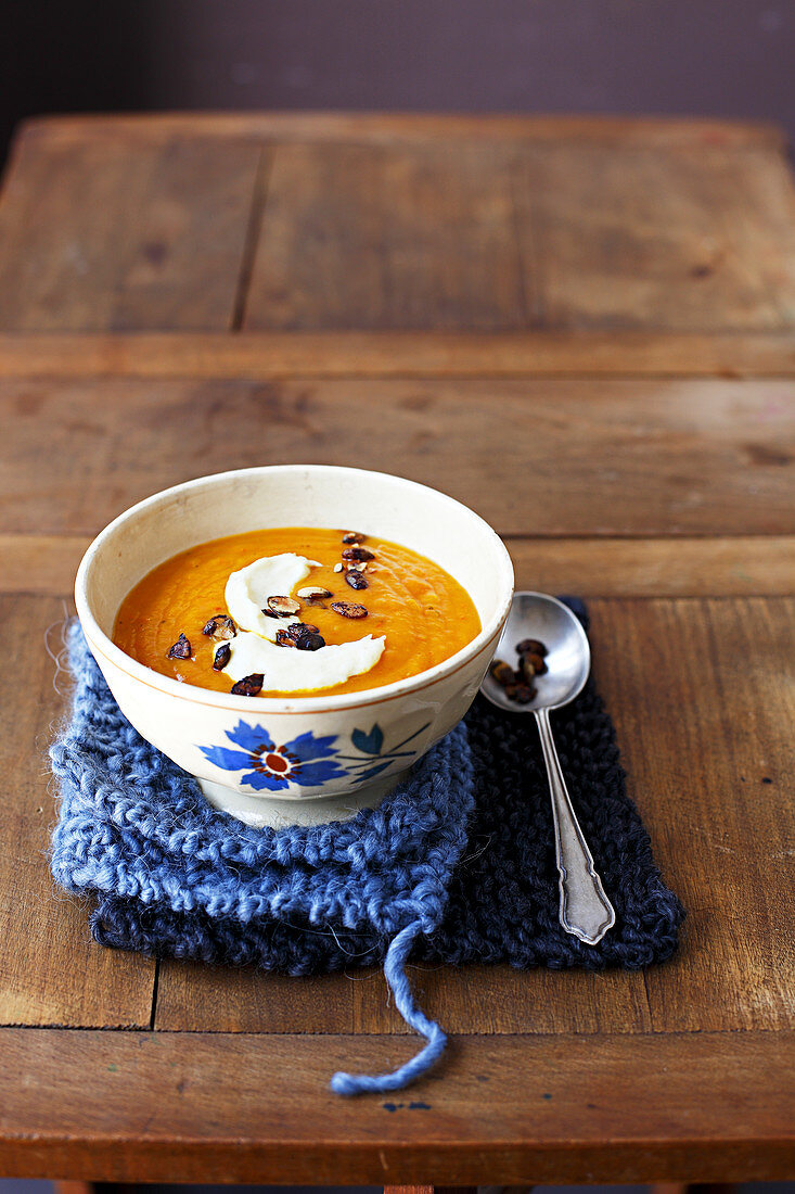 Cream of carrot and sweet potato soup with caramelized squash seeds