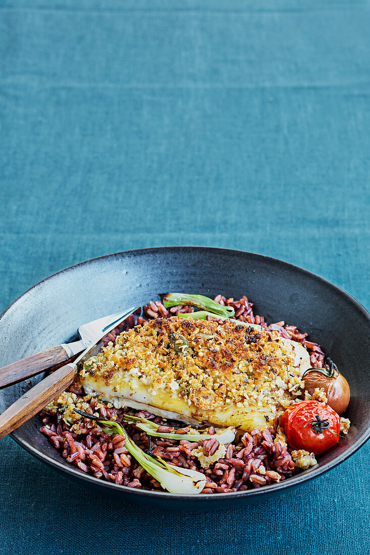 Lean fish fillet with crumble topping,red rice with tomatoes and spring onions