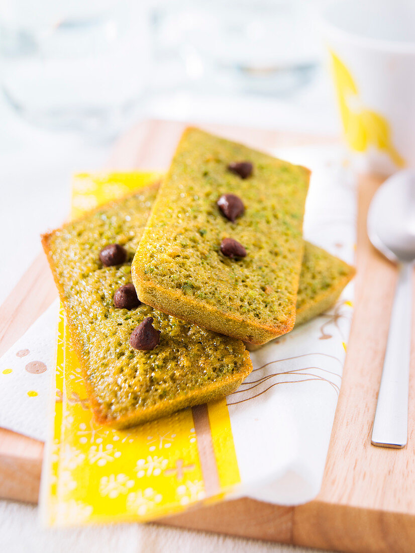 Pistachio Financiers decorated with chocolate drops