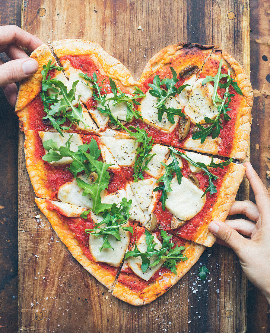 Tomato,mozzarella and mushroom heart-shaped pizza